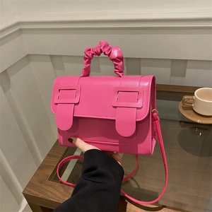Fuchsia minimalist crossbody bag with pleated handle and square buckle details