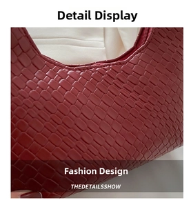 Macro shot of dark red woven texture and high-quality zipper detail of the shoulder bag