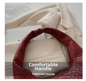 Close-up of red woven leather handbag detailing classic Intrecciato texture and craftsmanship
