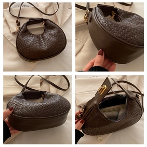 Detail view of woven crescent shoulder bag with golden hardware and textured finish