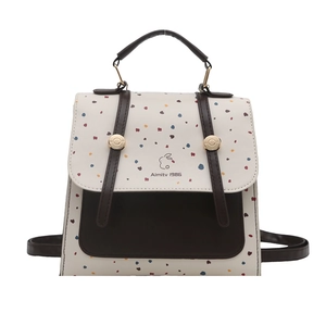 Chic cream and brown backpack with colorful polka dots and elegant gold hardware