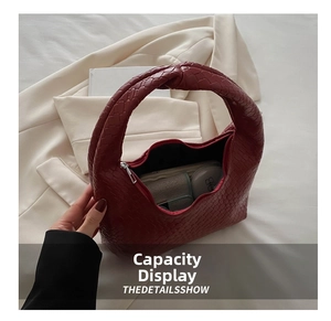 Capacity display of red woven leather shoulder bag showing makeup and wallet items