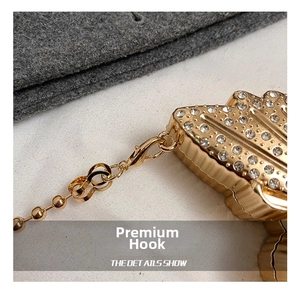 Close-up of golden lobster clasp with sparkling crystals for elegant mini evening bag
