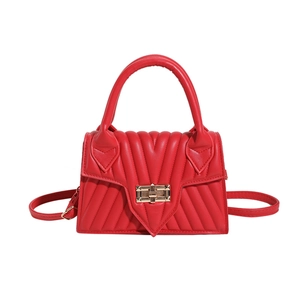 Modern red quilted leather handbag with V-shaped pattern and golden twist lock closure