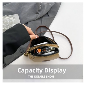 Dual-zipper khaki leather crossbody bag showing spacious interior for daily essentials