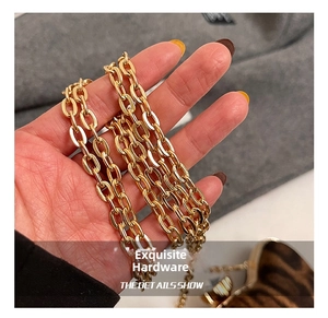 Detail of high-gloss gold metal chain strap for women handbags with smooth finish
