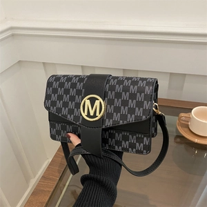 French style underarm bag with M-letter print and golden buckle in a cafe setting