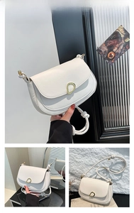 Detail of white saddle bag with gold oval buckle and knotted strap design
