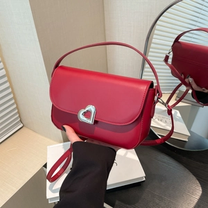 Red shoulder bag with silver heart lock and adjustable strap for women in winter fashion
