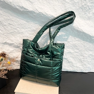 Fashionable dark green quilted puffer tote bag with glossy finish and long shoulder straps