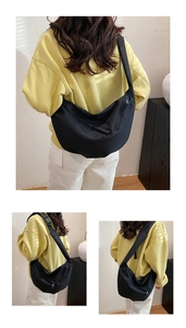 Detailed views of a black nylon crescent crossbody bag featuring adjustable straps and zipper