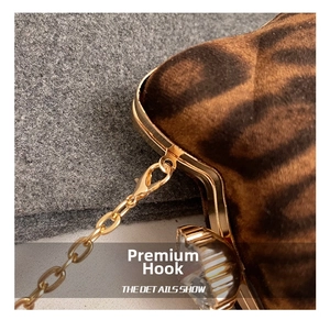 Detailed close-up of premium gold hardware hook on a leopard print faux fur shoulder bag
