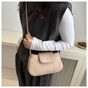 Detail of beige rectangular crossbody bag with Fashion & Bags text on smooth leather