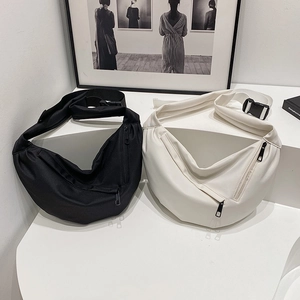 Minimalist large crossbody half-moon bags in black and white with adjustable straps
