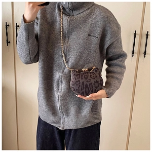 Cat-shaped crossbody bag with leopard texture and gold metal chain shown on model