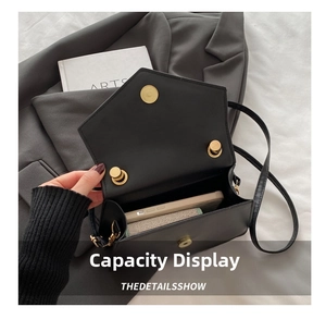 Interior view showing the capacity of a black square crossbody bag for daily essentials