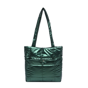 Deep green quilted puffer tote bag with metallic finish and silver button detail