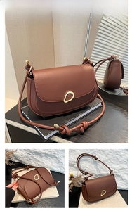 Detail of a brown PU leather crossbody bag featuring a golden circular metal buckle