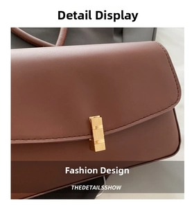 Detail of smooth brown leather texture and elegant gold rectangular metal buckle closure