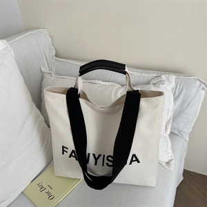 Large beige canvas tote bag with black FANYISSA lettering and wide shoulder straps