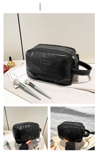 Détail de la trousse de toilette en cuir PU noir avec trois compartiments zippés