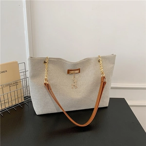 Large capacity canvas tote bag with brown leather straps and gold chain detail