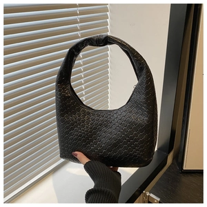 Close-up of black woven hobo bag showing intricate intrecciato texture and knotted handle