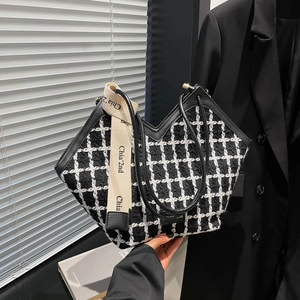 Chic black and white tweed tote bag with V-cut handle and canvas shoulder strap