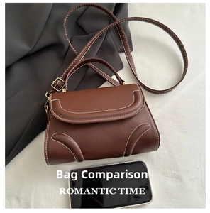 Size comparison of dark brown retro saddle bag with white stitching and a mobile phone