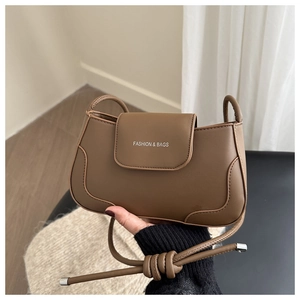 Detail of vintage brown leather shoulder bag with white Fashion & Bags text logo