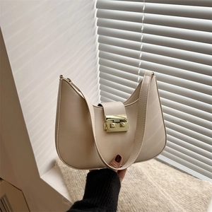 Minimalist beige half-moon underarm bag with elegant gold square metal buckle