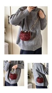Detail view of red leopard print cat-shaped mini bag with gold chain and furry texture