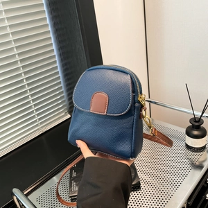 Blue lychee pattern crossbody bag with brown leather strap and golden metal zipper for women