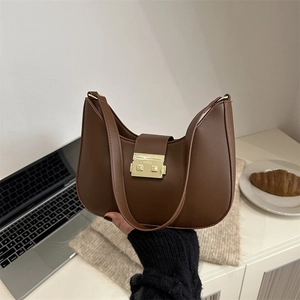 Chic dark brown faux leather crescent underarm bag with gold metal clasp for daily commute