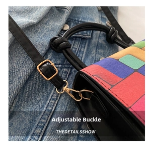 Detail of adjustable strap buckle on colorful plaid crossbody bag with knot handle