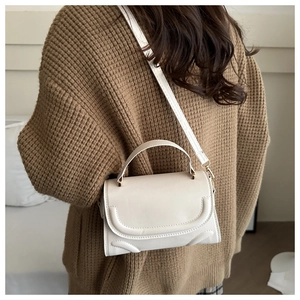 Chic cream white crossbody bag with unique double curved stitching and top handle