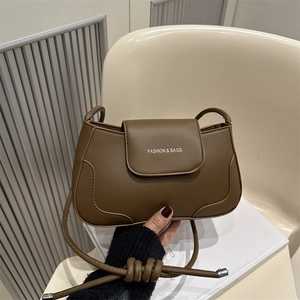 Brown PU leather shoulder bag with curved stitching and white fashion logo on front