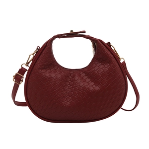 Deep red woven crescent handbag with gold hardware and adjustable crossbody strap