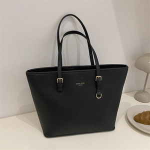Large black tote bag in pebbled leather texture with gold buckles and brand logo detail