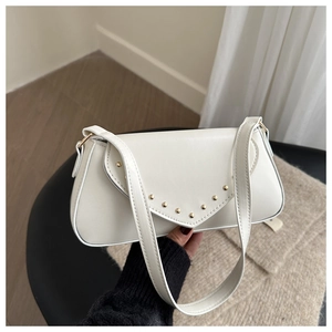 Close-up of cream white retro leather underarm bag featuring gold stud detailing