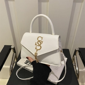 Elegant white minimalist handbag with gold logo, fringe tassel, and detachable strap