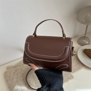 Retro dark brown crossbody box bag with white contrast stitching and gold metal hardware