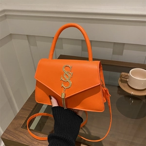 Bright orange minimalist handbag with metallic letter decor and fringe tassel detail