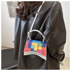 Mini silver shoulder bag with colorful geometric patterns shown on a model