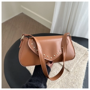 Detail view of the vintage brown PU leather shoulder bag with gold rivet decorations