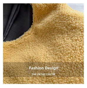 Close-up of bright yellow fluffy sherpa fleece fabric texture with dark lining