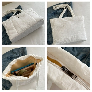 Quilted tote bag detail showcasing large capacity with daily essentials and metal zipper
