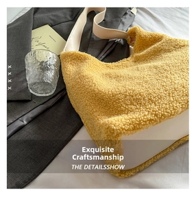 Detail of yellow plush sherpa tote bag with contrast cream leather straps and base