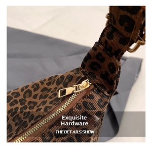 Close-up of premium leopard print canvas bag featuring a glossy gold metal zipper puller