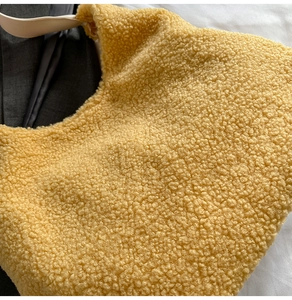 Detailed texture of bright yellow plush tote bag with a soft faux shearling finish